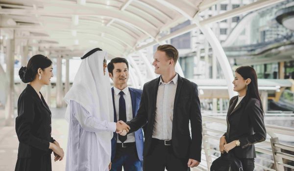 portrait-business-partners-greeting-one-another-by-handshaking-way-office